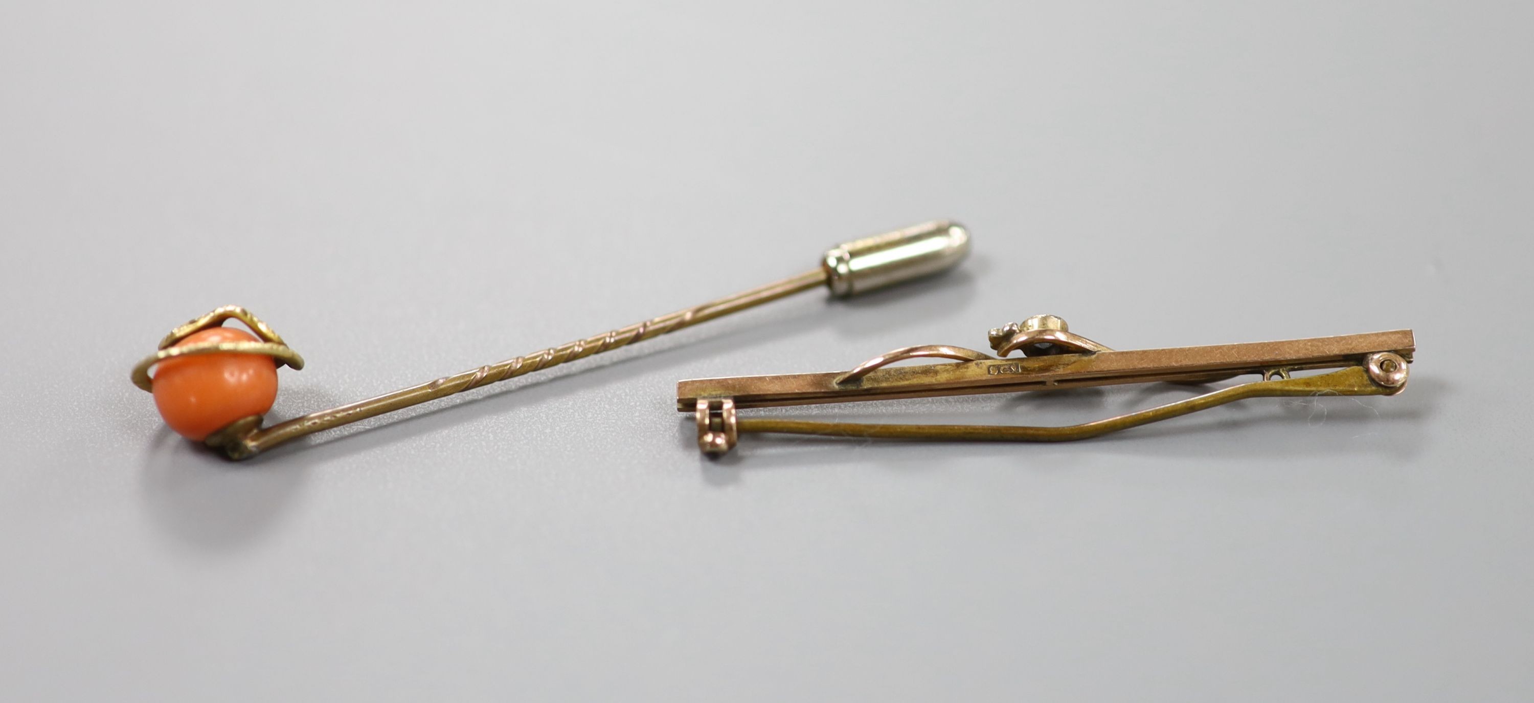 A gilt metal stick pin set with yellow metal serpent entwined coral bead, 60mm and a 9ct, sapphire and seed pearl set bar brooch, gross 2.4 grams.